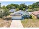 Charming single-story home with attached garage, inviting front yard and mature trees at 511 Coventry Ct, Mount Dora, FL 32757