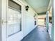 Inviting front porch features a white picket fence, glass door, and shade from the bright sunlight at 511 Coventry Ct, Mount Dora, FL 32757