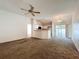 The open-concept living space boasts a ceiling fan and flows into the kitchen and lanai for seamless indoor-outdoor living at 511 Coventry Ct, Mount Dora, FL 32757