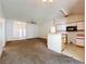 Bright living room with kitchen view and front door provides a welcoming atmosphere with ample space for relaxation and gatherings at 511 Coventry Ct, Mount Dora, FL 32757
