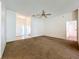 Bright living room with neutral walls, plush carpeting, ceiling fan, and a welcoming atmosphere at 511 Coventry Ct, Mount Dora, FL 32757