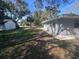 Side view of house showing landscaping and detached garage at 520 N Orange, Orange City, FL 32763