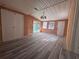 Sunroom with pool view, wood walls and laminate floor at 520 N Orange, Orange City, FL 32763