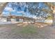 Large backyard with mature trees and a screened porch at 5300 Lido St, Orlando, FL 32807