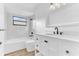 Elegant bathroom with marble-style walls, modern vanity with black hardware, and a sleek bathtub for a spa-like experience at 5300 Lido St, Orlando, FL 32807