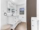 Bright bathroom with white vanity, modern fixtures, an illuminated mirror, and hardwood floors at 5300 Lido St, Orlando, FL 32807