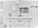 Stylish bathroom featuring a quartz countertop vanity, modern lighting, and sleek fixtures at 5300 Lido St, Orlando, FL 32807