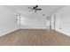 Bedroom featuring wood-look floors, a ceiling fan, and an open doorway at 5300 Lido St, Orlando, FL 32807
