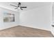 Bedroom with wood-look floors, a ceiling fan, and a closet at 5300 Lido St, Orlando, FL 32807