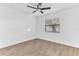 Bedroom featuring wood-look floors, a ceiling fan, and a view of the front yard at 5300 Lido St, Orlando, FL 32807