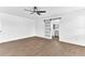 Bright bedroom features hardwood floors, recessed lighting, a ceiling fan, and barn door access to the bathroom at 5300 Lido St, Orlando, FL 32807