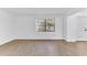 Entry room featuring a window to the front yard and white walls and wood-look floors at 5300 Lido St, Orlando, FL 32807