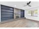 Contemporary living room with hardwood floors, custom built-in shelving, and a decorative fireplace at 5300 Lido St, Orlando, FL 32807