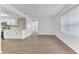 Bright living room with white walls, wood-look floors, and a view of the kitchen at 5300 Lido St, Orlando, FL 32807