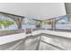 Enclosed porch with gray floors and screened windows overlooking the backyard at 5300 Lido St, Orlando, FL 32807