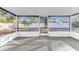 Bright, screened-in porch with a view of the lush backyard and a white perimeter fence at 5300 Lido St, Orlando, FL 32807