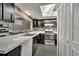 Galley kitchen with dark cabinets, white counters and appliances at 5419 Fairwood Way # 305, Orlando, FL 32808