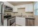 Updated kitchen, featuring white cabinets and stainless steel appliances at 5624 Balboa Dr, Orlando, FL 32808