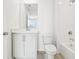 Modern bathroom with white vanity, tiled shower, and chrome fixtures at 5680 Brosnan Rd, St Cloud, FL 34771