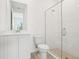 A stylish bathroom featuring a vanity, toilet, and tiled walk-in shower at 5680 Brosnan Rd, St Cloud, FL 34771