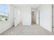 Bright bedroom features soft carpet, and closet and bathroom entrance, plus a window with a neighborhood view at 5680 Brosnan Rd, St Cloud, FL 34771