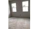 Unfurnished bedroom with drywall and two windows at 5680 Brosnan Rd, St Cloud, FL 34771