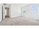 This bedroom features plush gray carpeting, a neutral color palette, and bright natural light at 5680 Brosnan Rd, St Cloud, FL 34771