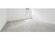 Bright bedroom featuring neutral carpeting, white walls and a large window at 5680 Brosnan Rd, St Cloud, FL 34771