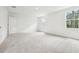 Bright bedroom featuring neutral carpeting, white walls and plenty of natural light at 5680 Brosnan Rd, St Cloud, FL 34771