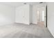 This bedroom features plush gray carpeting, a neutral color palette, and abundant natural light at 5680 Brosnan Rd, St Cloud, FL 34771