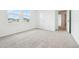 Bright bedroom features soft carpet, and lots of natural light from the large windows at 5680 Brosnan Rd, St Cloud, FL 34771