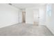 This bedroom features plush gray carpeting, a neutral color palette, and an open closet at 5680 Brosnan Rd, St Cloud, FL 34771