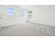 This bedroom features plush gray carpeting, a neutral color palette, and bright natural light at 5680 Brosnan Rd, St Cloud, FL 34771