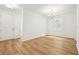 Inviting foyer with wood flooring, a white door, and elegant chandelier at 5680 Brosnan Rd, St Cloud, FL 34771