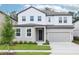 Charming two-story home featuring a well-manicured lawn and a two-car garage at 5680 Brosnan Rd, St Cloud, FL 34771