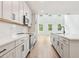 Beautiful kitchen with white cabinetry, stainless steel appliances, and a spacious island at 5680 Brosnan Rd, St Cloud, FL 34771