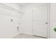 Bright white laundry room with wire shelving and tile floors at 5680 Brosnan Rd, St Cloud, FL 34771