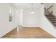 Cozy living area with wood floors, a staircase, and access to the backyard at 5680 Brosnan Rd, St Cloud, FL 34771