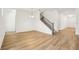 Bright living area featuring wood floors and a staircase leading to the upper level at 5680 Brosnan Rd, St Cloud, FL 34771