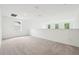 Spacious loft area with neutral carpet and natural light from windows at 5680 Brosnan Rd, St Cloud, FL 34771