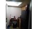 Simple kitchen with refrigerator and wooden cabinets at 7628 Forest City Rd # 056 Aka H, Orlando, FL 32810