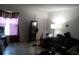 Living room with tiled floor, sofa, and floor lamp at 7628 Forest City Rd # 056 Aka H, Orlando, FL 32810