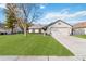 Single-story house with a two-car garage and well-maintained lawn at 8024 Lesia Cir, Orlando, FL 32835