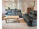 Living room with leather furniture and a view into the kitchen at 8024 Lesia Cir, Orlando, FL 32835