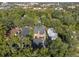 Aerial view of a two-story house nestled amongst lush greenery at 817 Antonette Ave, Winter Park, FL 32789