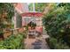 Landscaped backyard with stone path, seating area, and lush greenery at 817 Antonette Ave, Winter Park, FL 32789