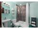 Updated bathroom with teal accents and a walk-in shower at 817 Antonette Ave, Winter Park, FL 32789