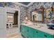 Charming bathroom with teal vanity and floral wallpaper at 817 Antonette Ave, Winter Park, FL 32789