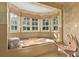 Relaxing bathroom with large soaking tub and multiple windows at 817 Antonette Ave, Winter Park, FL 32789