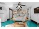 Bright bedroom with daybed, teal floors, and built-in closet at 817 Antonette Ave, Winter Park, FL 32789